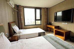 A hotel room with two beds, a TV, a desk, and a window with curtains. - Youyou Boutique Hotel (Xiong County Government Branch) (Xiong County)