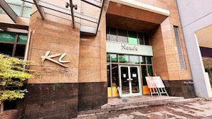 A building with a sign reading "KCL" and "Nono's" on the entrance.
