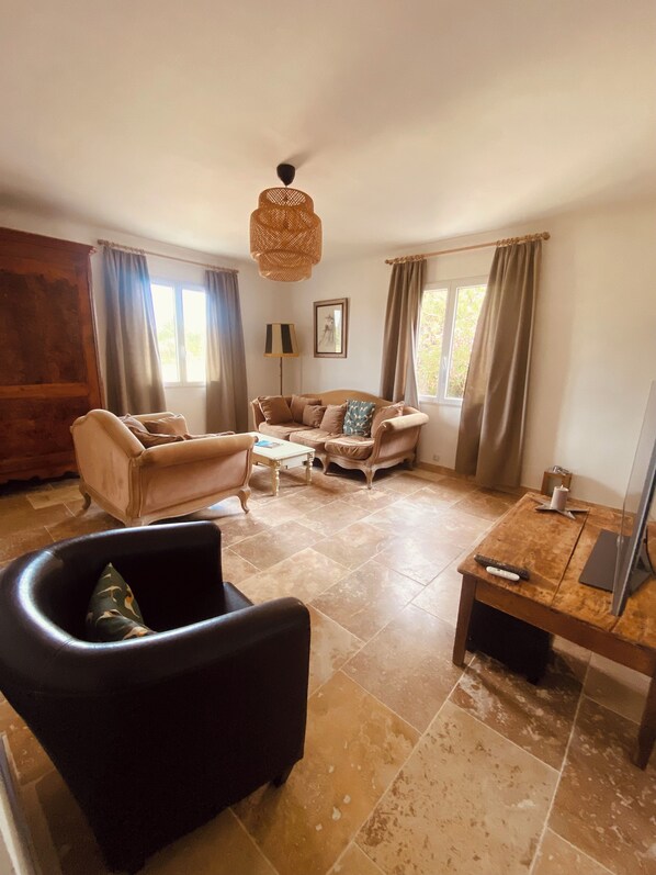 A living room with a sofa, armchair, coffee table, and a TV stand. - Mas in Drôme provençale with swimming pool (La Baume-de-Transit)