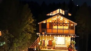A two-story building with a deck and outdoor seating area. - The Good Vibes by Aero Stays (Kasauli)