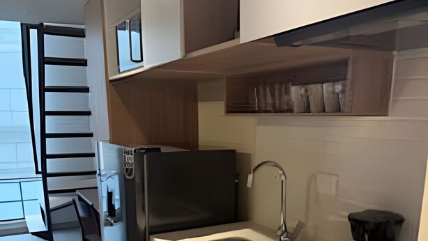 A modern kitchen with a double sink, a refrigerator, and a coffee maker. - Vivo52 (Bogotá)