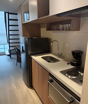 A modern kitchen with a double sink, a refrigerator, and a coffee maker. - Vivo52 (Bogotá)