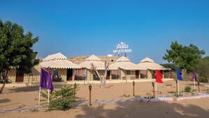 A desert resort with multiple tents and a sign indicating a hotel. - Star Desert Camp Jaisalmer  (Jaisalmer)