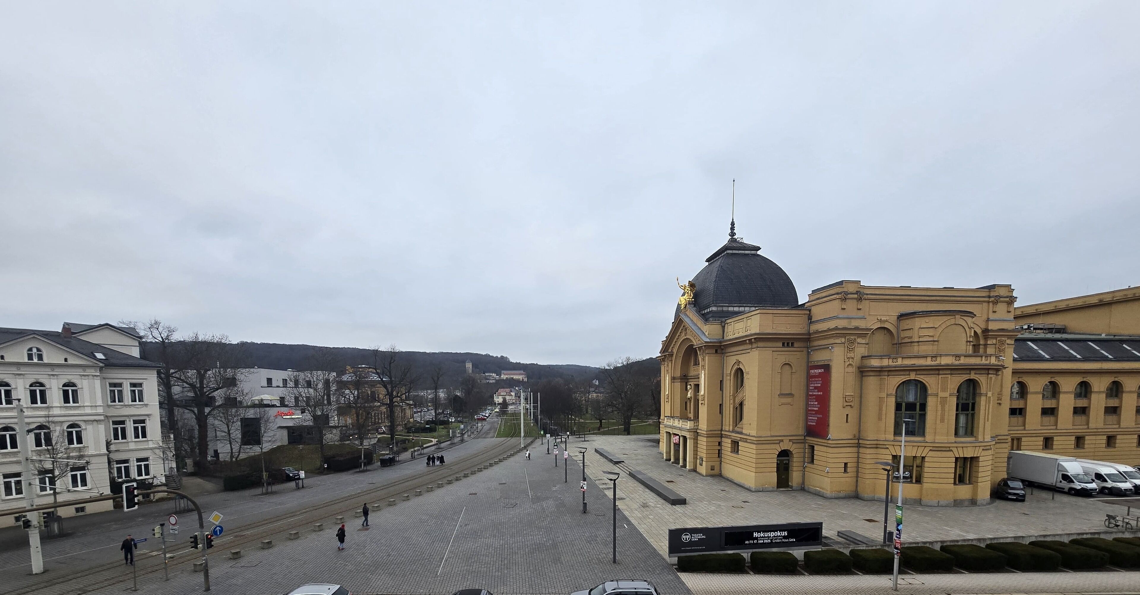 A large, historic building with a prominent dome and a sign indicating it is a hotel.