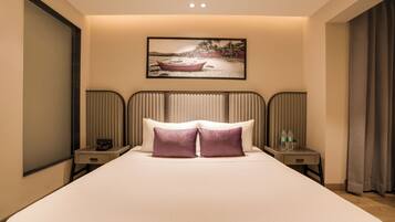 A hotel room with a large bed, two bedside tables, a headboard, a painting on the wall, and a window with curtains.