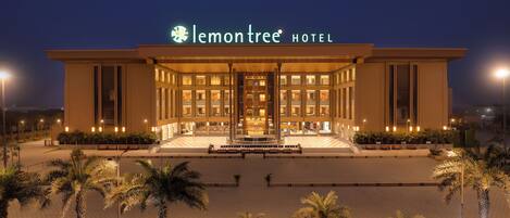 A modern hotel with a prominent sign reading "lemontree HOTEL".
