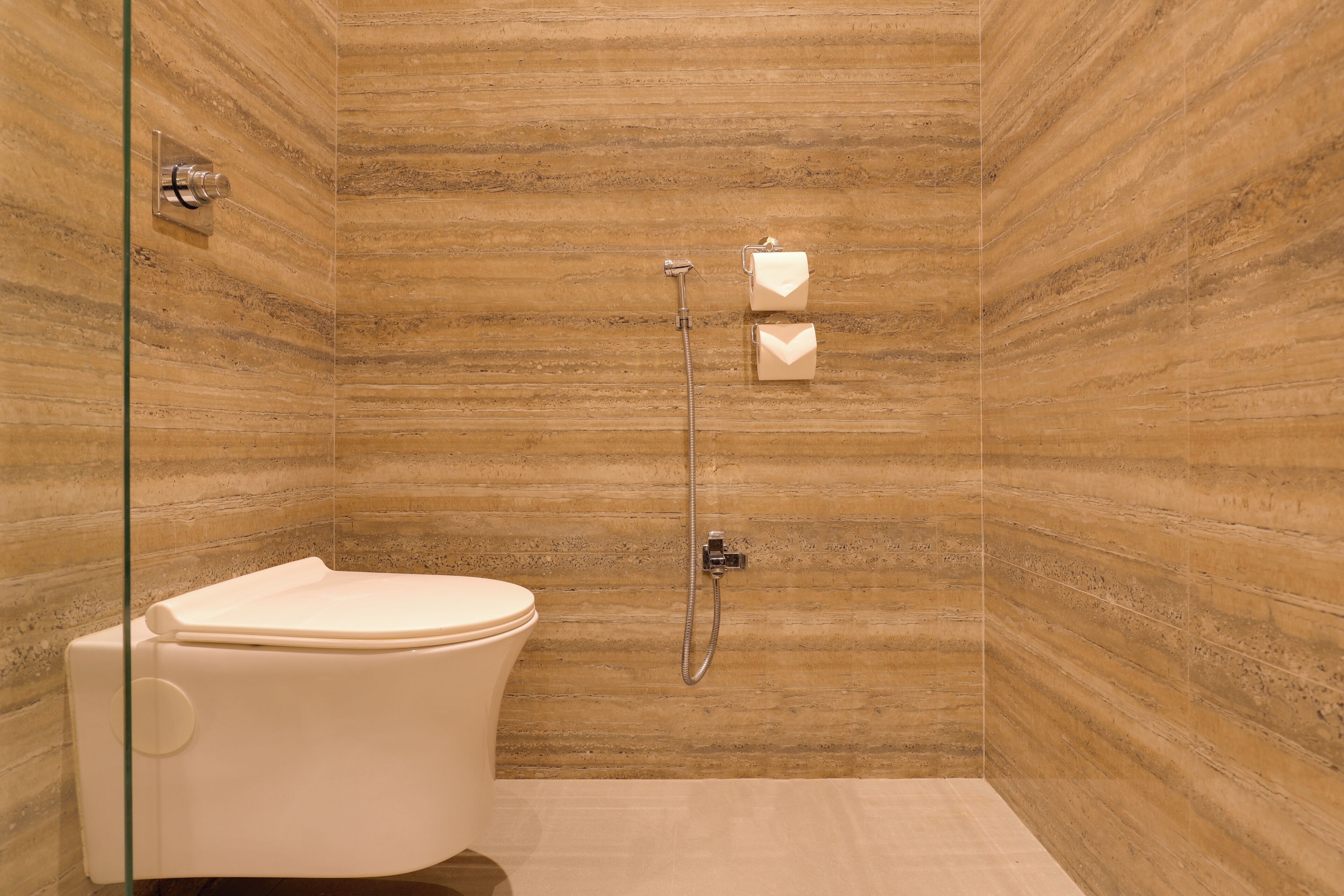 A bathroom with a shower, toilet, and towel rack.