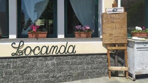 A restaurant named "Locanda" with a chalkboard menu outside. - albergo da teresa (Bardineto)