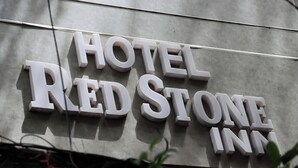 A sign for 'HOTEL REDSTONE INN' with large, white, three-dimensional letters on a grey background. - Hotel Red stone inn (New Delhi)