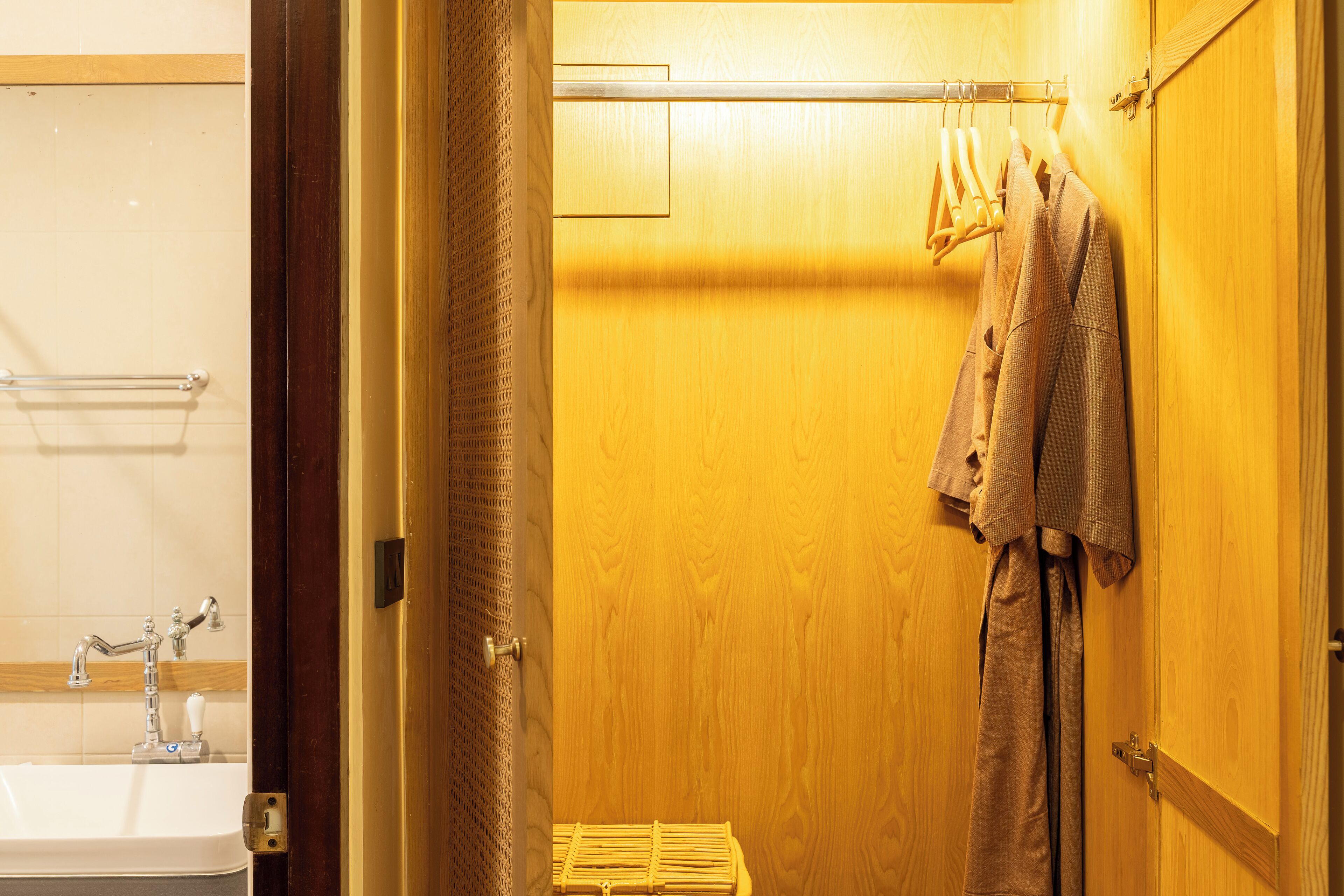 A wooden door with a towel rack holding two towels.