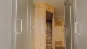 A hallway with lockers on both sides and a wooden door at the end. - SNite Hotel & Dorm-Danang Dragon Bridge (Da Nang)