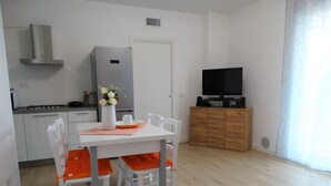 A modern kitchen with white cabinets, a stainless steel range hood, and a built-in oven. - Prestigiosa - Two Bedroom Apartment, Sleeps 5 (Alghero)