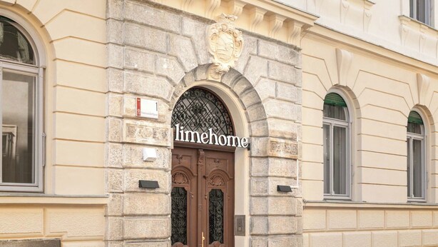 A building with a stone facade, a central entrance with a brown door, and the name 'limehome' displayed above the door. - Limehome Graz Trauttmansdorffgasse (Graz)