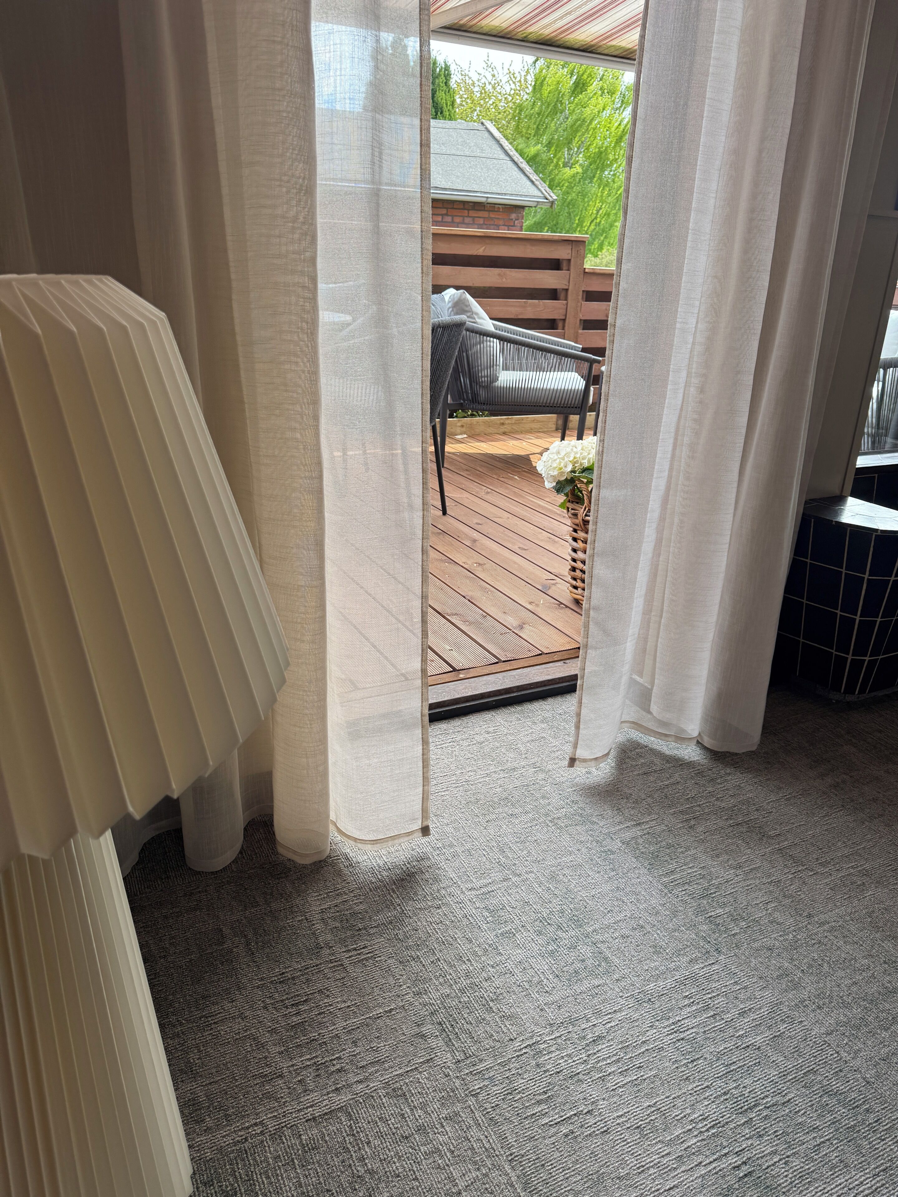 A room with a view of an outdoor deck area.