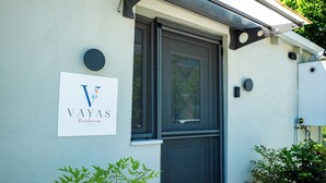 A building with a sign reading "VAYAS Residences" and a door with a window. - Vayas Residences Legacy (Trikala)