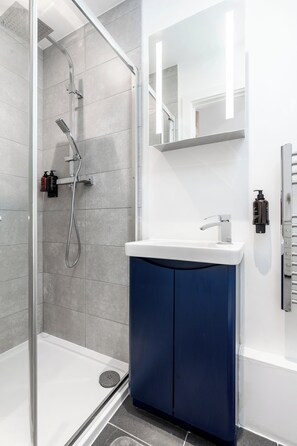 Shower, hair dryer, towels, soap