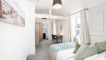 2 habitaciones, escritorio y tabla de planchar con plancha