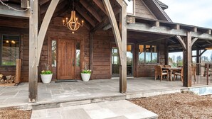 A wooden cabin with a covered porch, stone steps, and a chandelier. - The Elmwood Wellness Estate (Dundas)