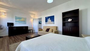 A modern hotel room with a large bed, a sofa, a TV, and artwork on the walls. - Villetta Certosina 2 (Racale)