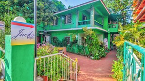 A green two-story house with a sign reading "Jacks Place". - Jacks Calangute place (Calangute)