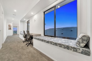 Enjoy a peaceful view from the large window, with a comfortable bench and desk area to work or relax.