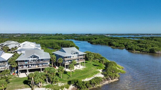 A coastal hotel with multiple buildings, a river, and dense greenery. - Fenimore Mill 6DE Dual Delight, Two Units in One - Families/Groups/Gulf Front! (Cedar Key)