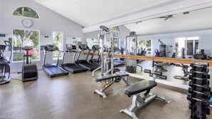 A gym with treadmills, weight machines, and a bench. - Relaxing 3BR / 2BA Naples Retreat - w Private Heated Pool (Naples)