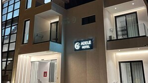 A modern hotel with a prominent sign reading "ADELE HOTEL". - Adele Hotel Ksamil (Ksamil)