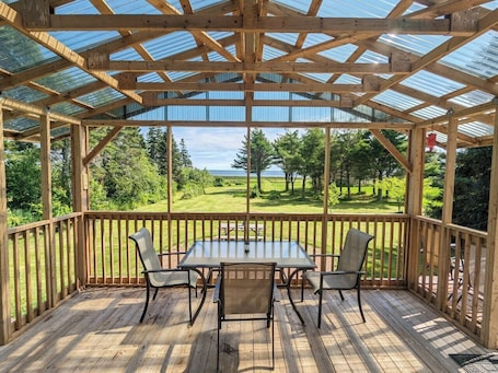 Outdoor dining. Oceanfront Cozy Cottage • Private Beach, Hot Tub, Pool & Boardwalk
