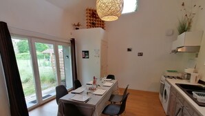 A modern kitchen with a dining area, large windows, and a view of the outdoors. - FARMHOUSE GITE WITH SHARED POOL - A CHANGE OF SCENERY FOR FAMILY AND FRIENDS (Cachen)