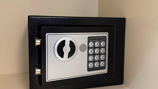 A black safe with a keypad and a keyhole. - Shehu Villa Ksamil (Ksamil)