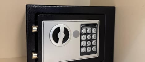 A black safe with a keypad and a keyhole.