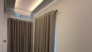 A hallway with grey curtains, a ceiling-mounted air conditioner, and a tiled floor. - Shehu Villa Ksamil (Ksamil)