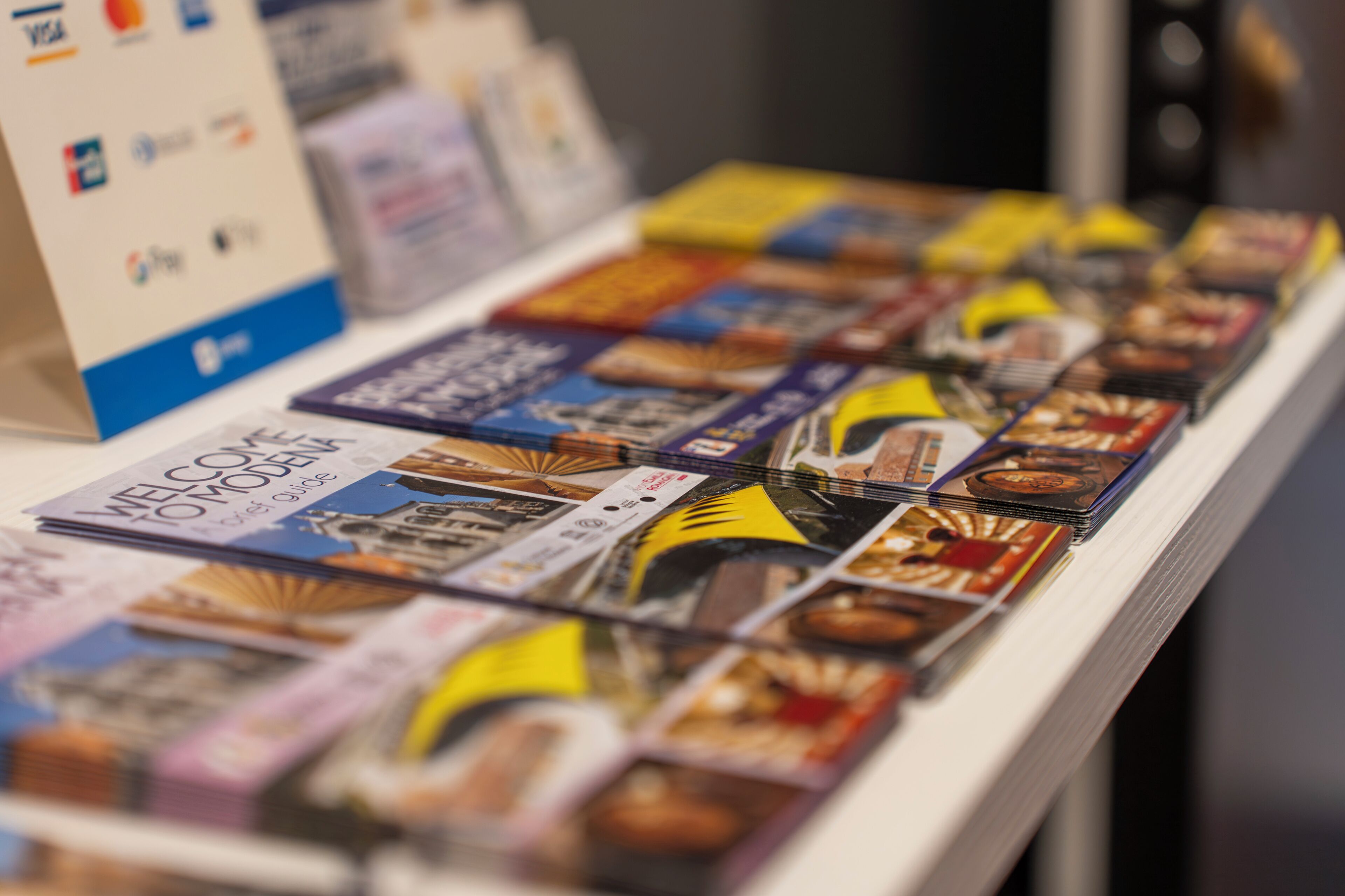 A display of travel guides and brochures on a table.
