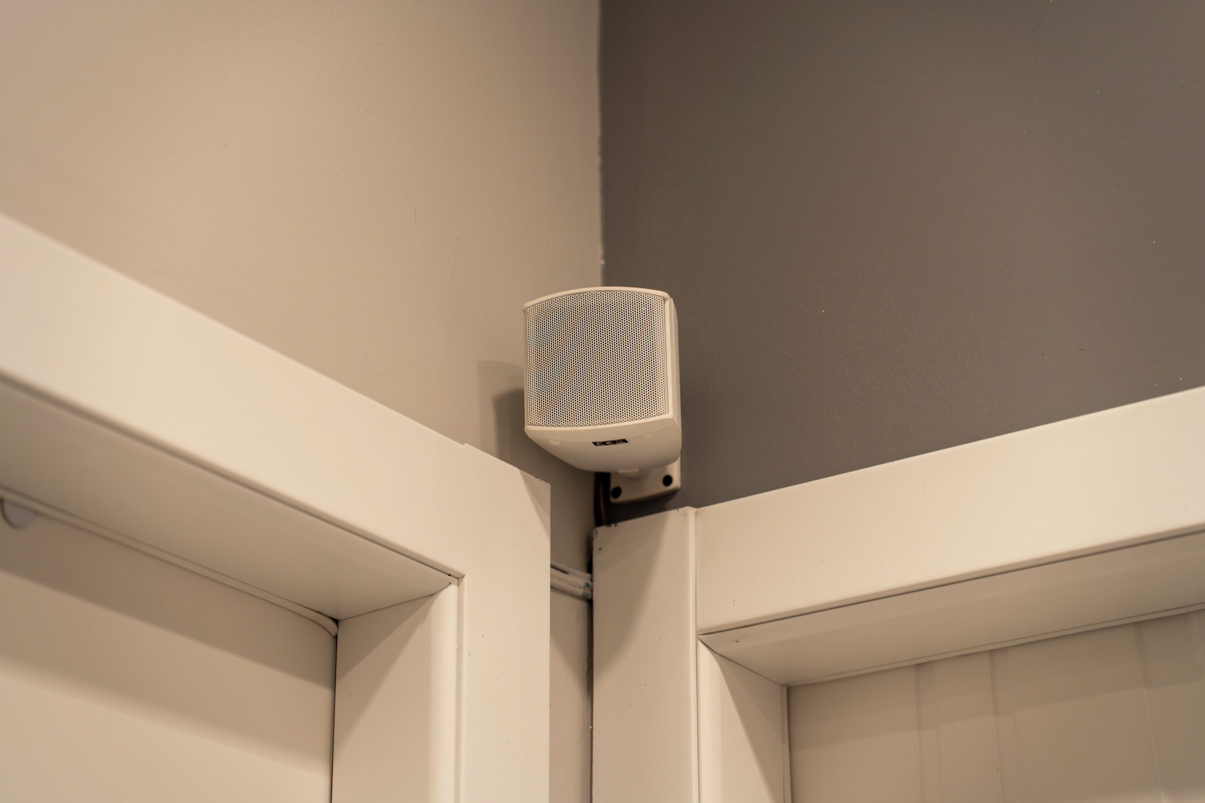 A corner of a room with a white door and a white wall.