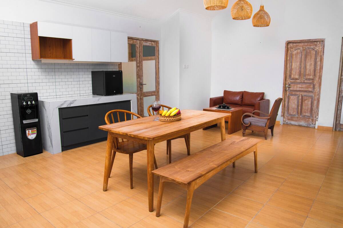 A compact living space with a kitchen, dining area, and seating.