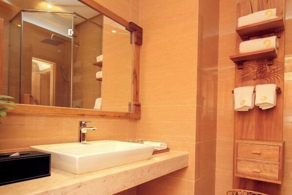 A bathroom with a large mirror, a white sink, and wooden towel racks.