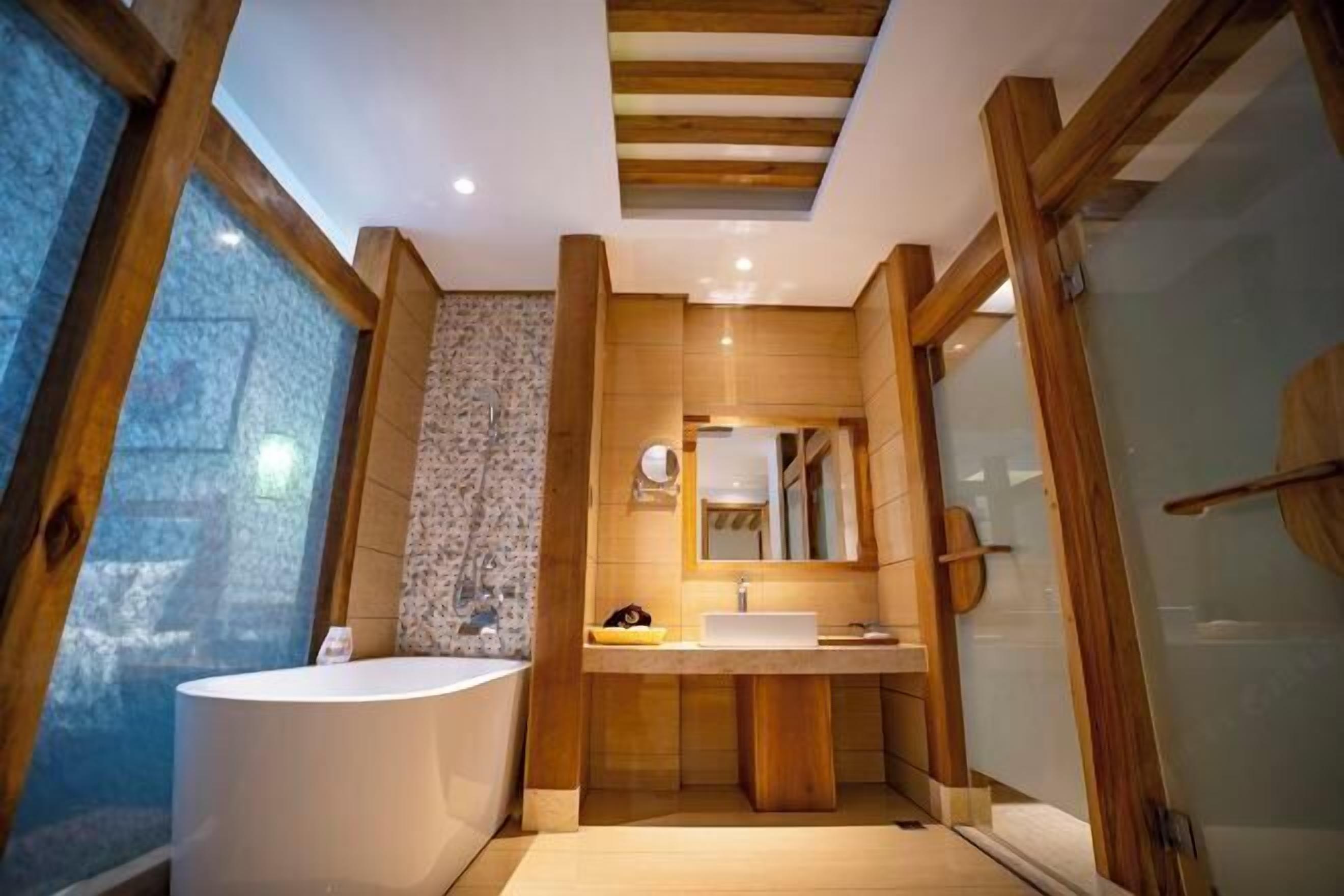 A modern bathroom with a freestanding bathtub, wooden accents, and a large mirror.