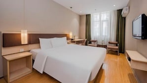 A hotel room with a large bed, bedside tables, a desk, a chair, a TV, and a window with curtains. - Homeinn Motel Hotel (Nanjing Medical University Longmian Avenue Subway Station) (Nanjing)