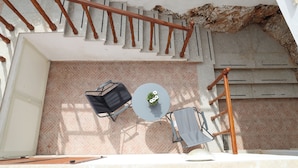 A rooftop terrace with a table and chairs, a small garden, and a staircase. - Villa Maria (San Vito Lo Capo)