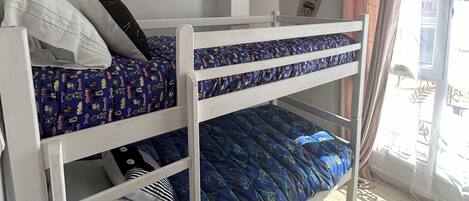 A bunk bed room with a panda wall decal, a surfboard decoration, and a yellow hanging light.