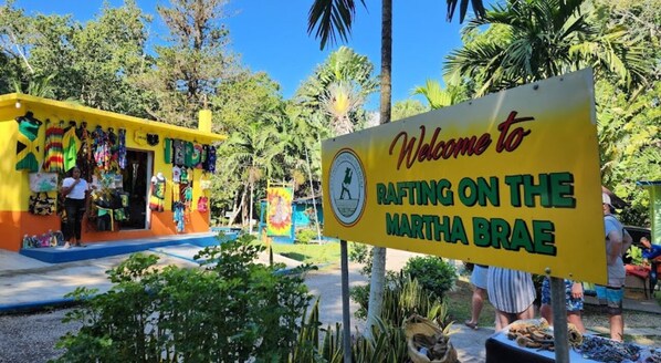 A colorful building with a sign welcoming visitors to Rafting on the Martha Brae.