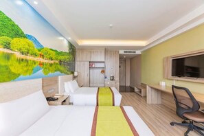 A hotel room with two beds, a desk, a chair, a television, and a kitchen area. - Yuncheng Juhetai Hotel (Yanhu South Wind Square) (Yuncheng)