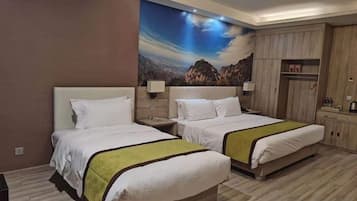 A hotel room with two beds, a nightstand, a wardrobe, and a large landscape mural on the wall.