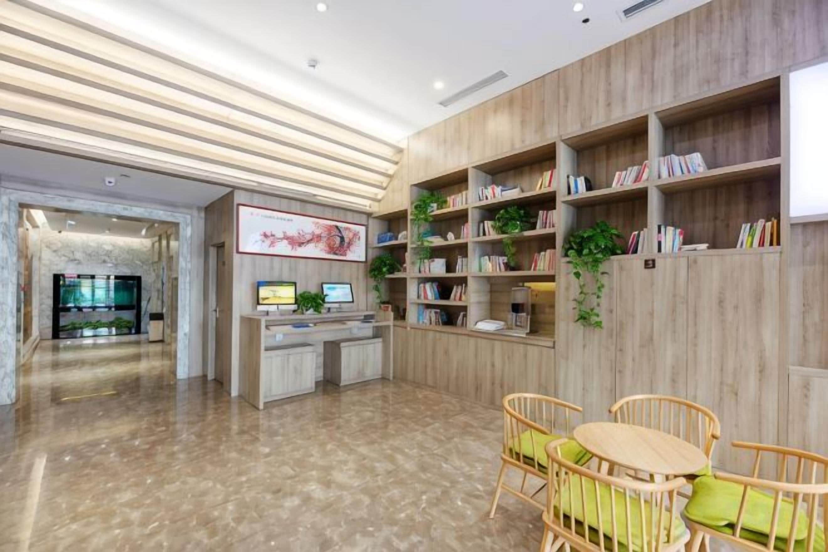 A reception area with a reception desk, seating area, and bookshelves.