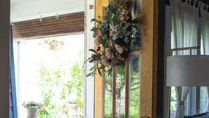 A wooden door with glass panels, a small potted plant, and a lamp on the right.