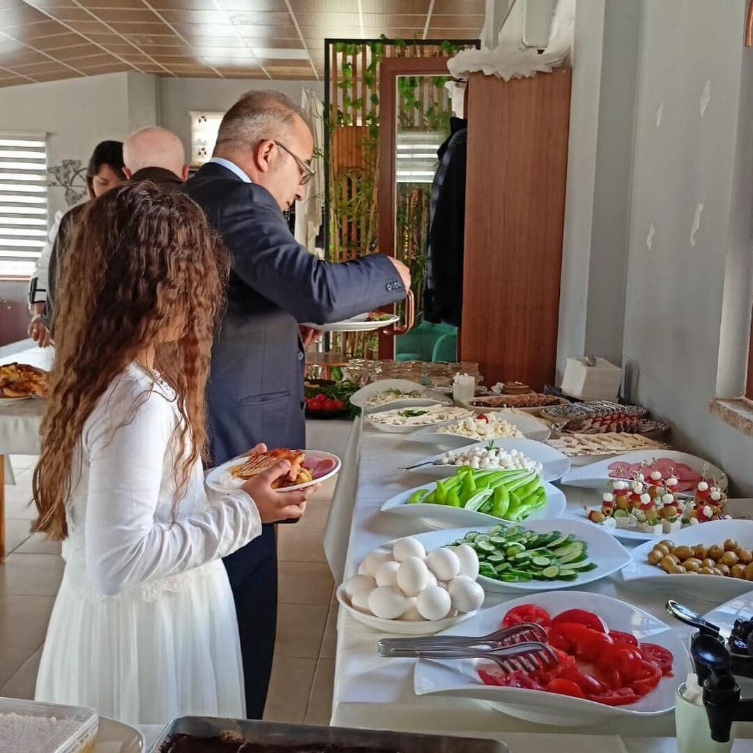 A buffet setup with various food items including eggs, vegetables, and olives.