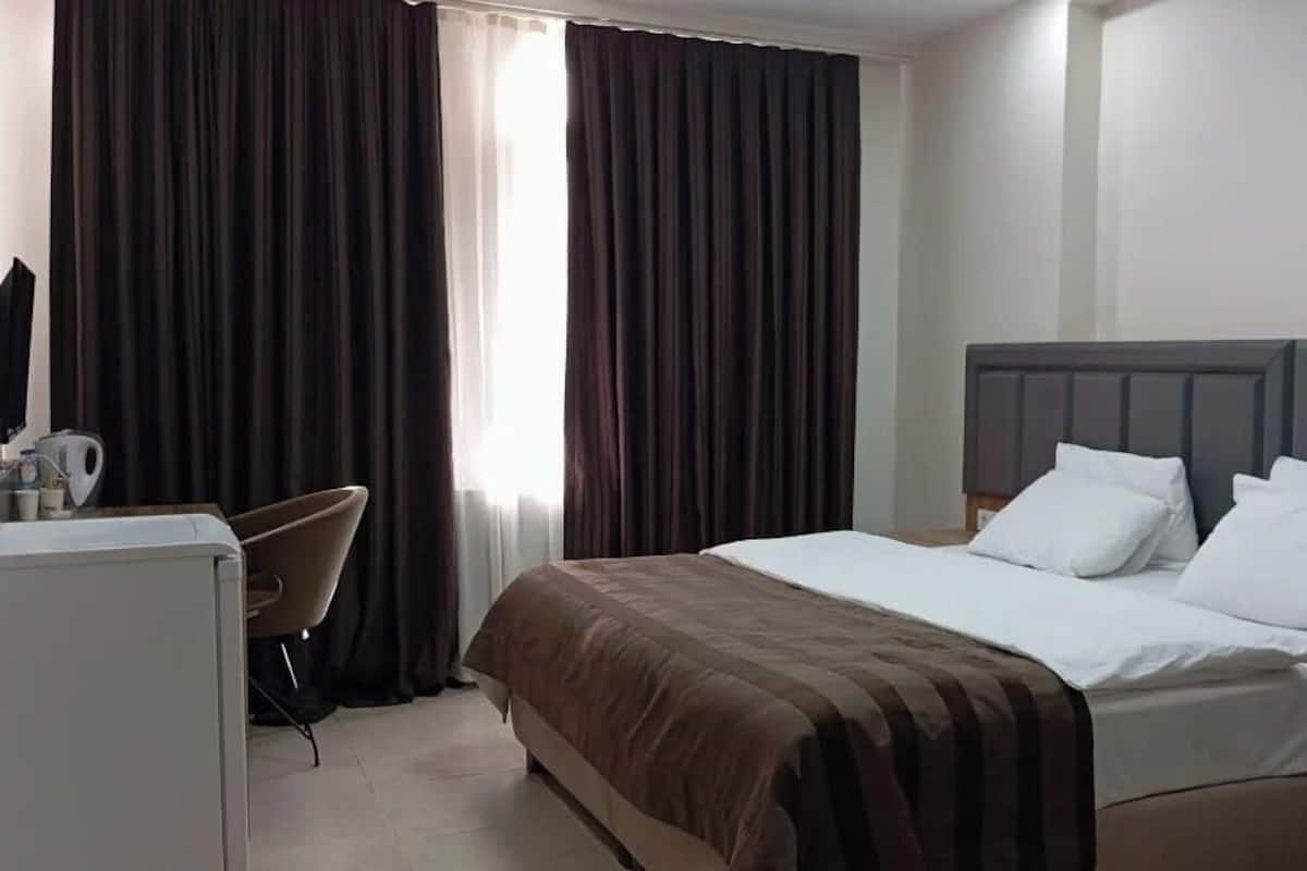 Standard Room | Desk, laptop workspace, blackout curtains, iron/ironing board