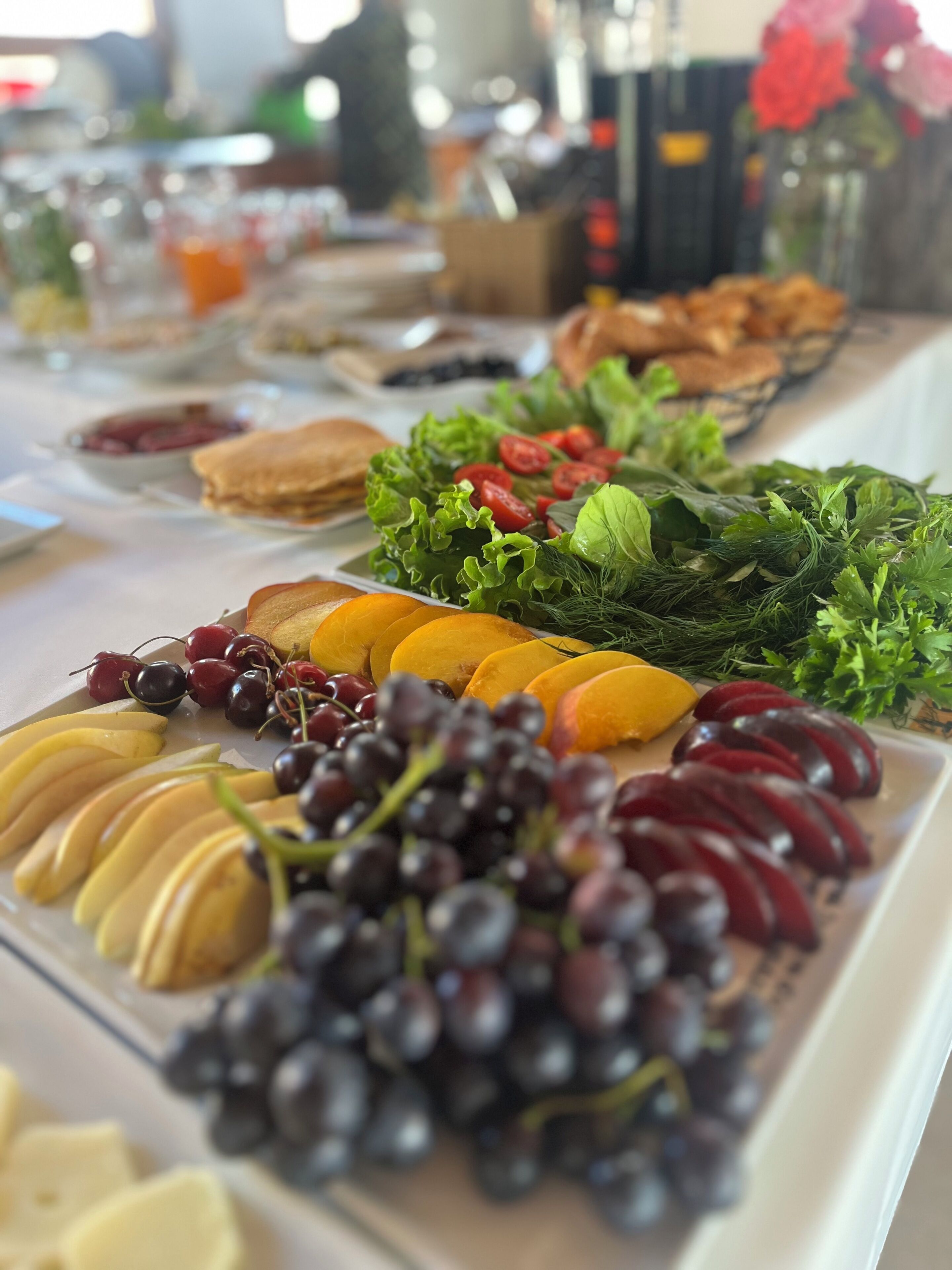A buffet table with various fruits and vegetables.