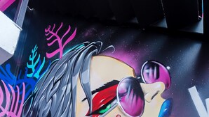 Une fresque murale éclatante, aux motifs abstraits et aux couleurs vives.